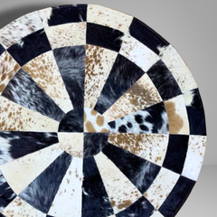 Handmade Sunburst Round Cowhide Rug crafted from natural hair-on hide panels. Radial patchwork design, 9 sq ft. Luxurious, unique, and artisan-stitched for modern & rustic interiors.