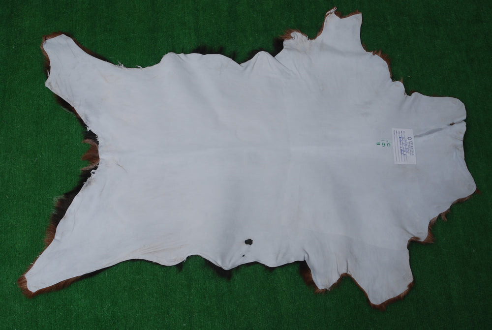 Luxurious Brown and Black Goat Hide Rug with Unique Patterns and Non-Slip Suede Back - Sustainable Eco-Friendly Accent Piece - Celestial Leather Limited