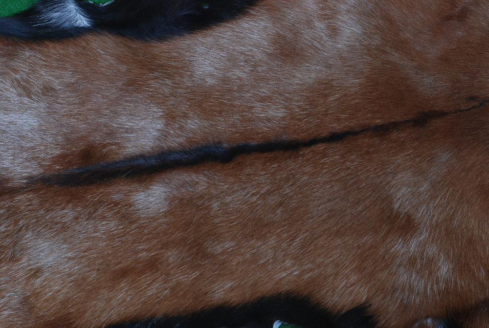 Luxurious Brown and Black Goat Hide Rug with Unique Patterns and Non-Slip Suede Back - Sustainable Eco-Friendly Accent Piece - Celestial Leather Limited