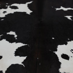 Luxury Handcrafted Medium Brown and White Cowhide Rug - Hypoallergenic, Non-Slip Backing, One-of-a-Kind Natural Beauty