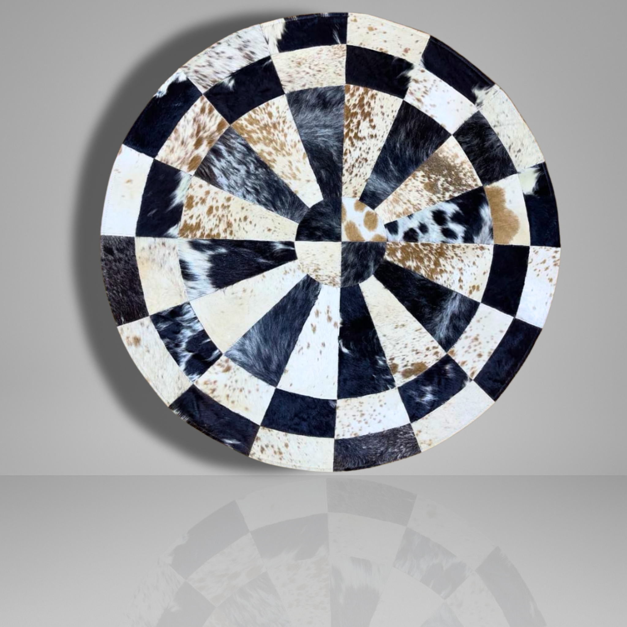 Handmade Sunburst Round Cowhide Rug crafted from natural hair-on hide panels. Radial patchwork design, 9 sq ft. Luxurious, unique, and artisan-stitched for modern & rustic interiors.