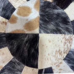 Handmade Sunburst Round Cowhide Rug crafted from natural hair-on hide panels. Radial patchwork design, 9 sq ft. Luxurious, unique, and artisan-stitched for modern & rustic interiors.