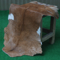 Elegant Brown and White Goat Hide Rug - Perfect Accent for Living Room or Bedroom