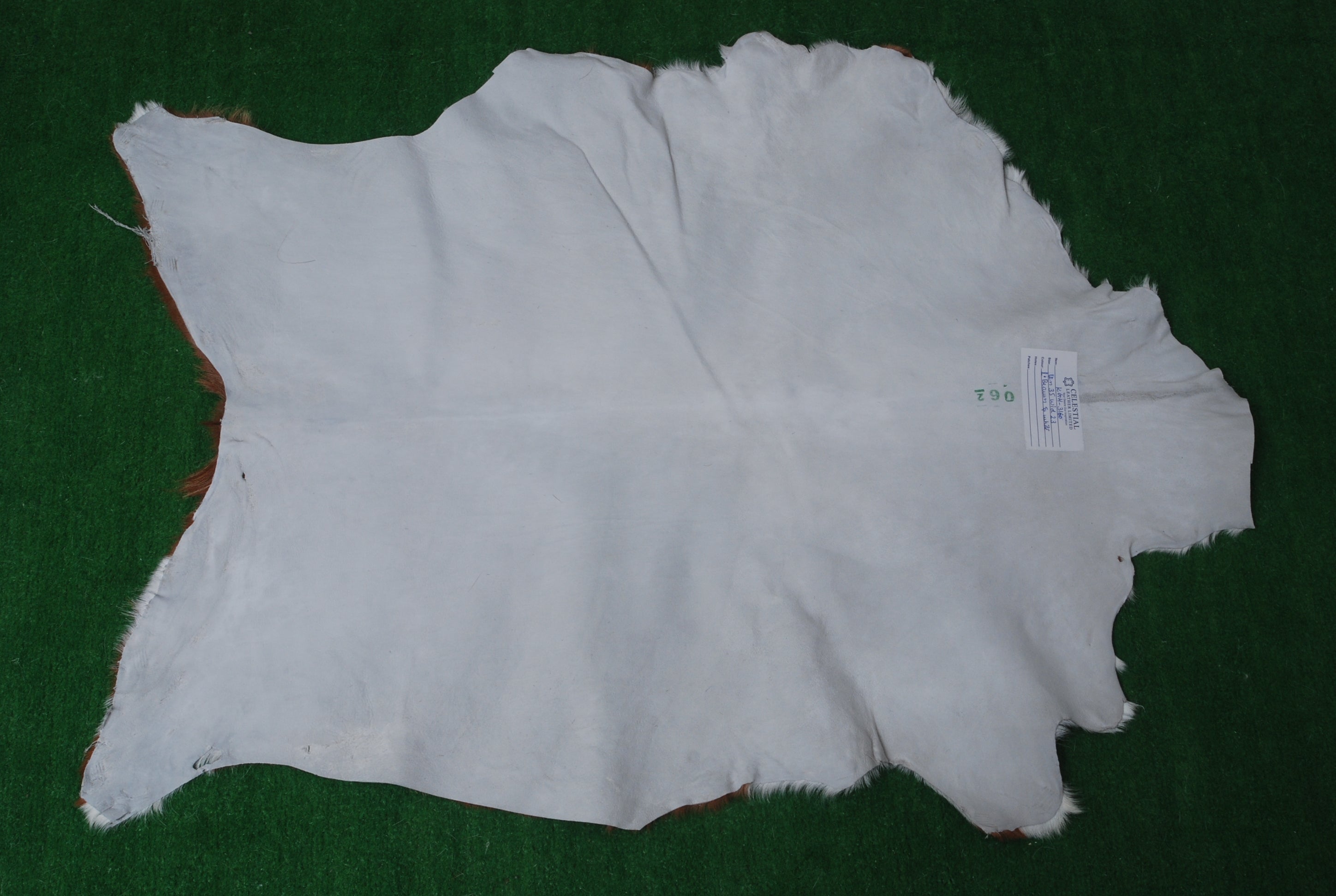 Handcrafted Brown and White Goat Skin Rug - Soft, Durable, and Elegant Décor