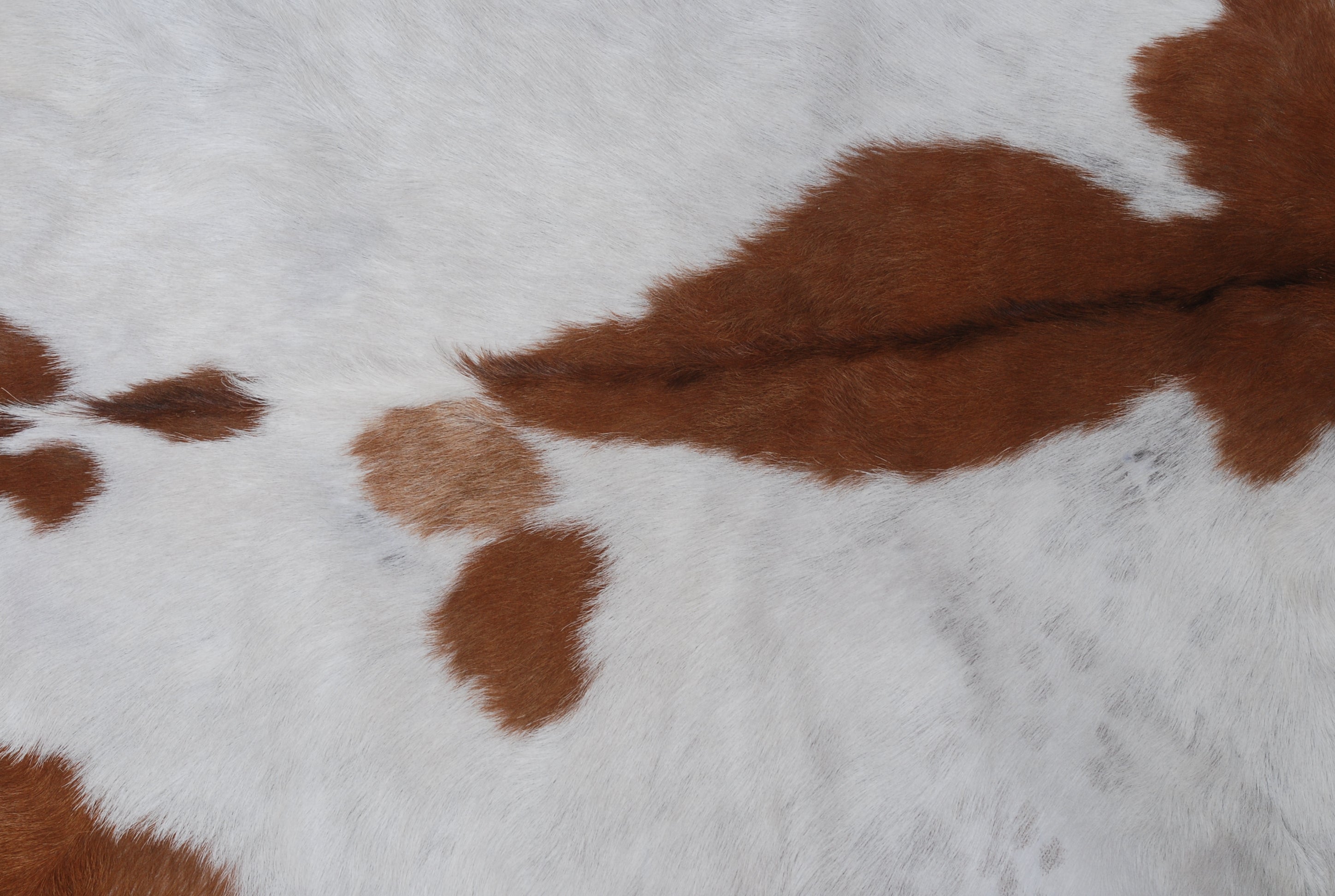 Handcrafted Brown and White Goat Skin Rug - Soft, Durable, and Elegant Décor
