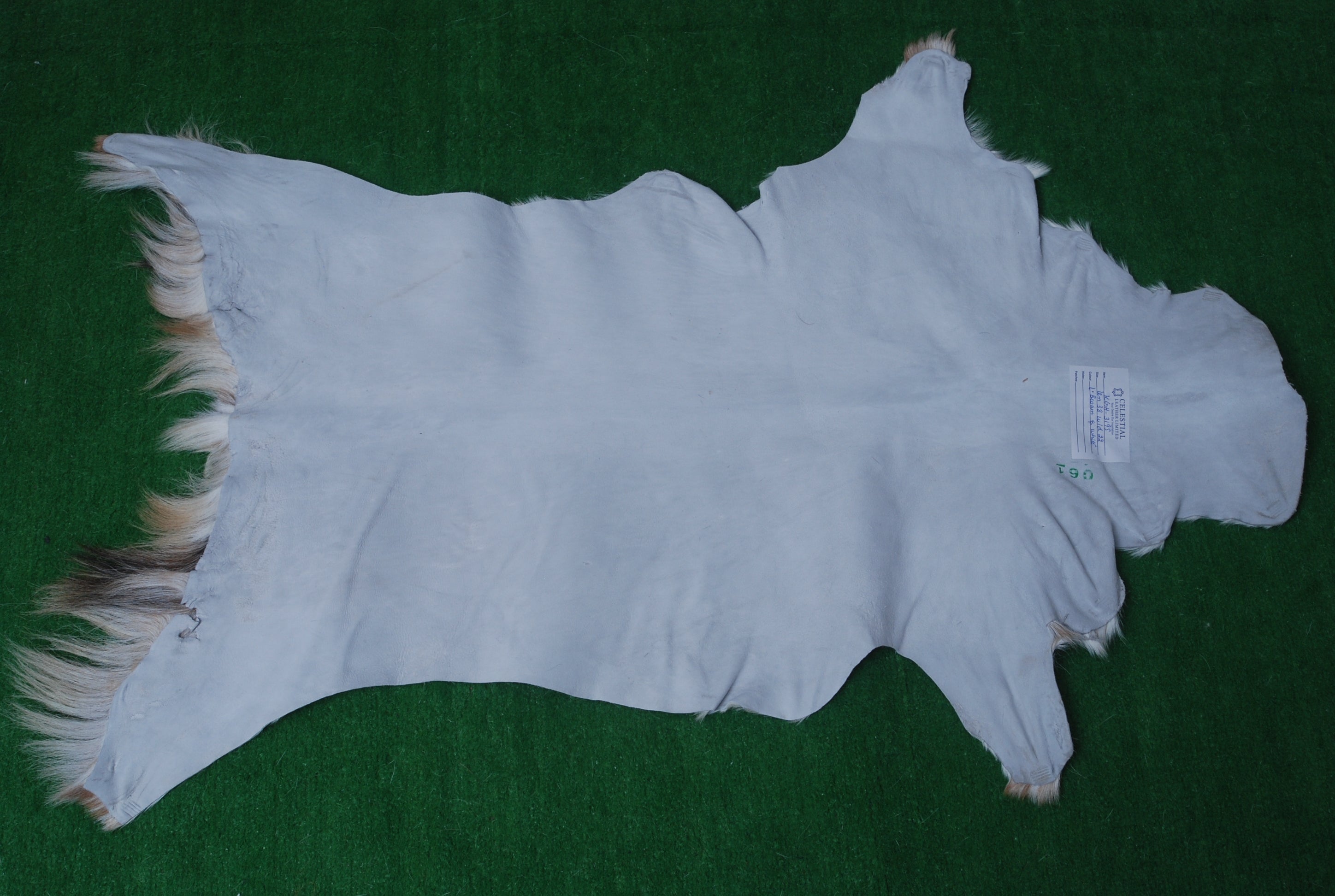 Handcrafted Brown and White Goat Skin Rug - Soft, Durable, and Elegant Décor