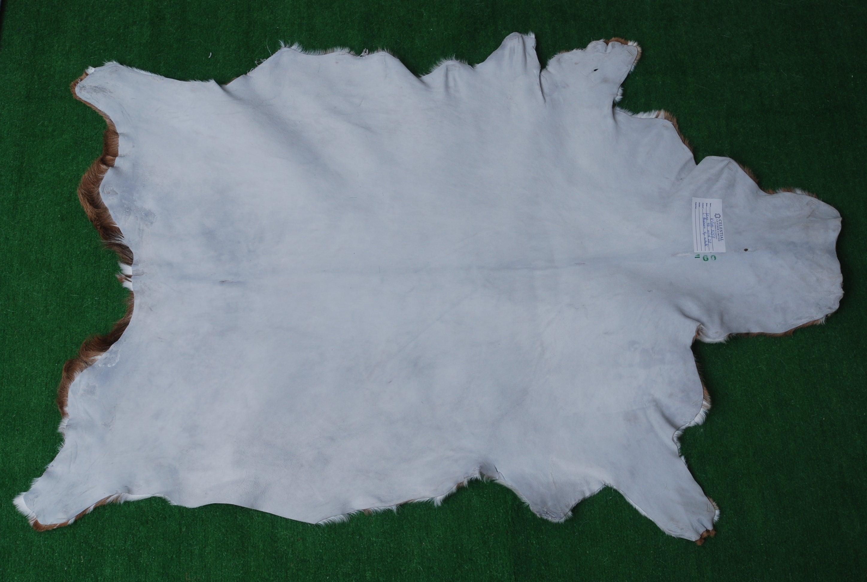 Handcrafted Brown and White Goat Skin Rug - Soft, Durable, and Elegant Décor