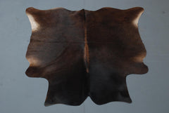 Luxurious Medium Brown and White Cowhide Rug for Rustic Home Decor - Handcrafted Natural Hide with Unique Markings