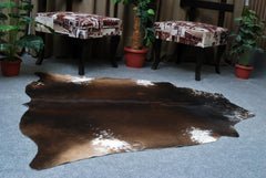 Luxurious Dark Brown and White Cowhide Rug for Sophisticated Lounge Decor - Celestial Leather Limited