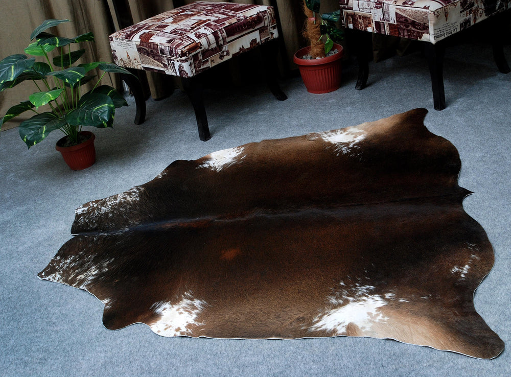 Luxurious Dark Brown and White Cowhide Rug for Sophisticated Lounge Decor - Celestial Leather Limited